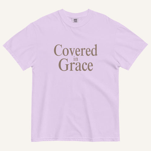 Lavender t-shirt with 'Covered in Grace' text on a white background