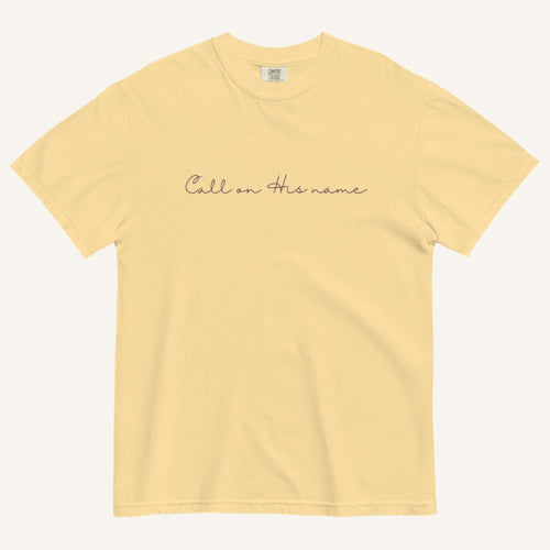 Yellow t-shirt with 'Call on His name' text on a white background
