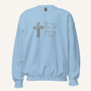light blue sweatshirt with cross design and 'No longer lost, but found by Him' text on a cream background