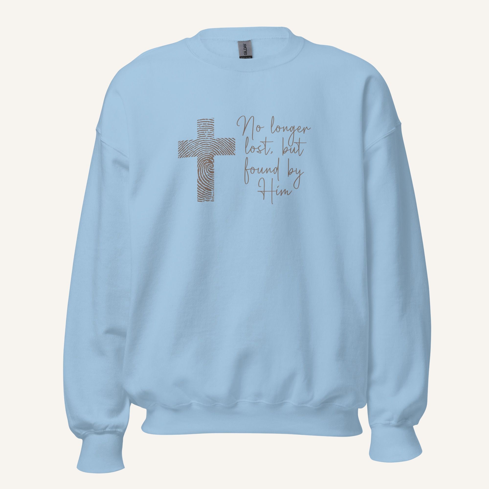 light blue sweatshirt with cross design and 'No longer lost, but found by Him' text on a cream background
