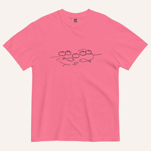A hot pink short-sleeve crewneck t-shirt with a black graphic of two fish and 5 loaves of bread on a line and the cursive text 'Everyone Ate' across the chest, displayed flat against a light beige background.