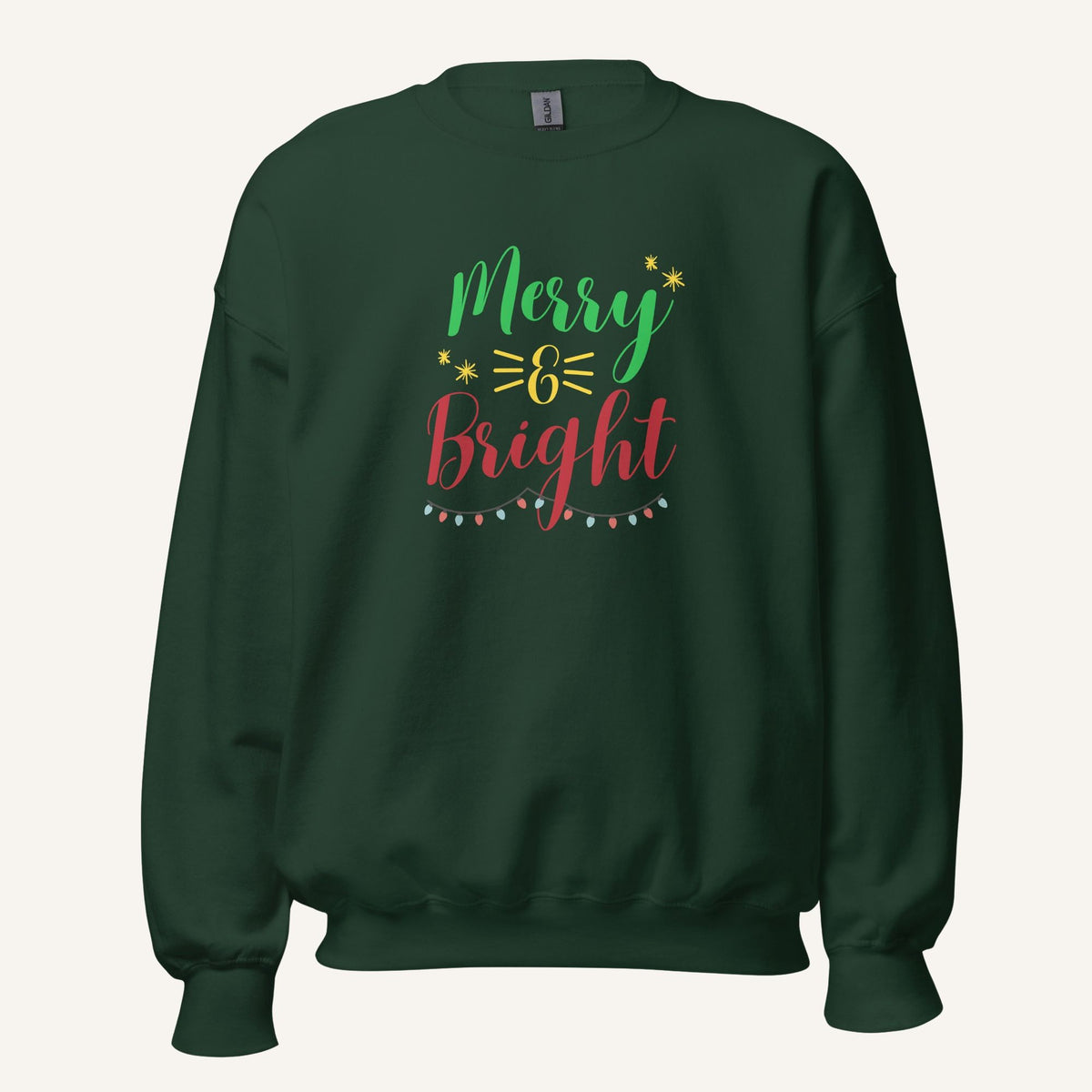 green crewneck sweatshirt with "Merry & Bright" colorful text with Christmas lights and star graphics