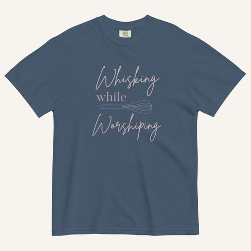 blue t-shirt with "Whisking while worshiping" text and a whisk graphic