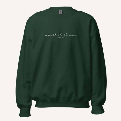green sweatshirt with 'Searched & known' text
