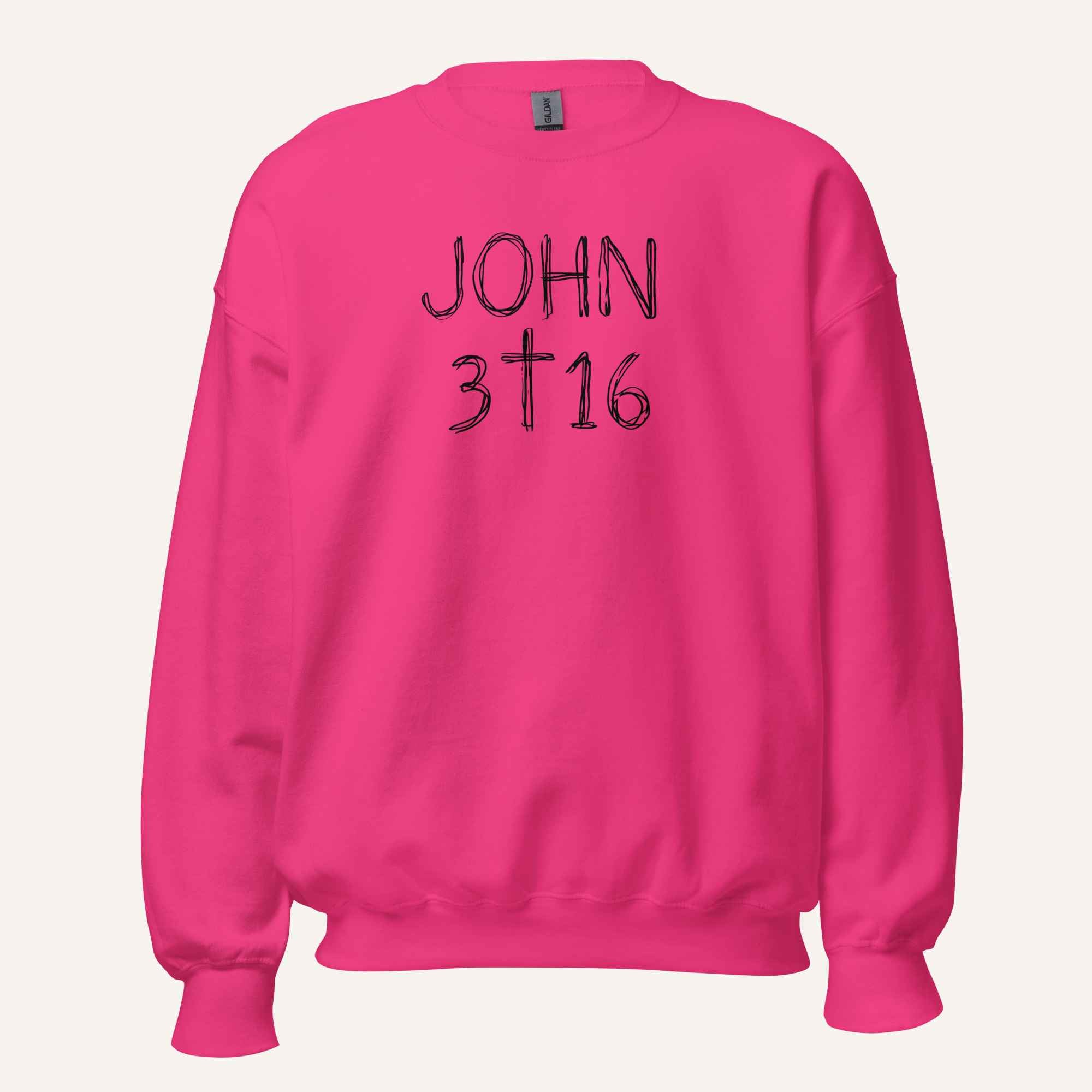 a bright pink crewneck sweatshirt with 'John 3 16' text with cross graphic between the 3 & 16 on a light cream background