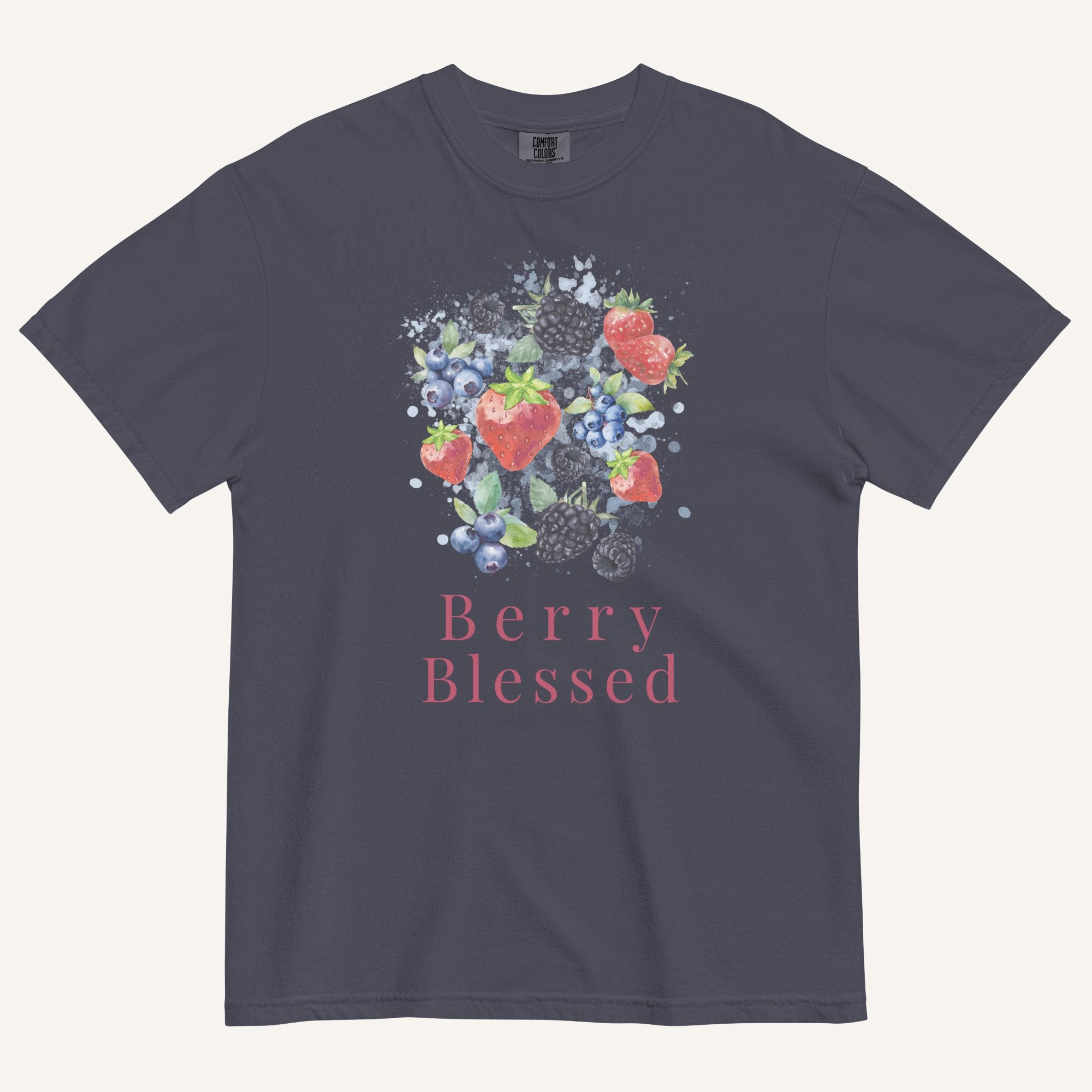 A dark gray crewneck t-shirt featuring a watercolor-style graphic of strawberries, blueberries, and blackberries with the text 'Berry Blessed' printed below in pink, displayed on a light cream background.