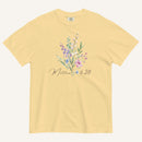 Yellow t-shirt with floral design and 'Matthew 6:28' text on a white background