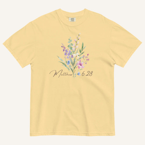 Yellow t-shirt with floral design and 'Matthew 6:28' text on a white background