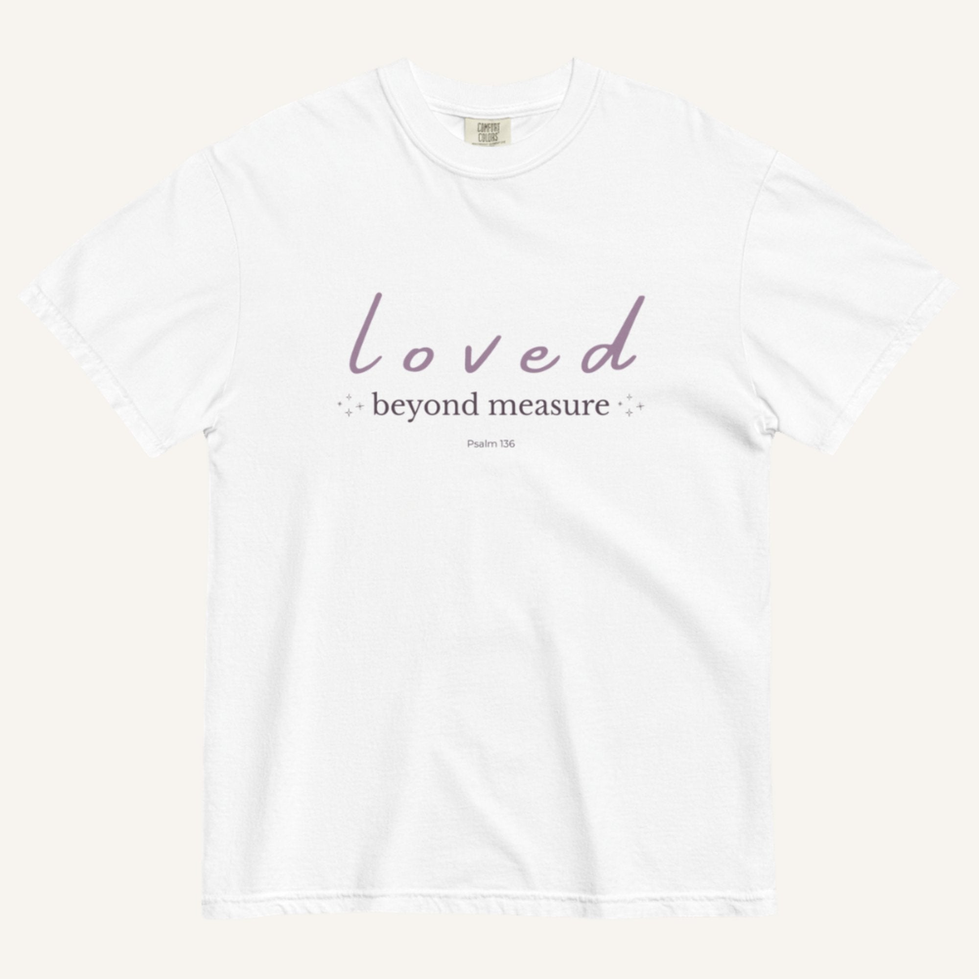 White t-shirt with 'loved beyond measure' text on a white background