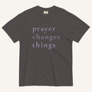 Gray t-shirt with 'prayer changes things' text on a white background