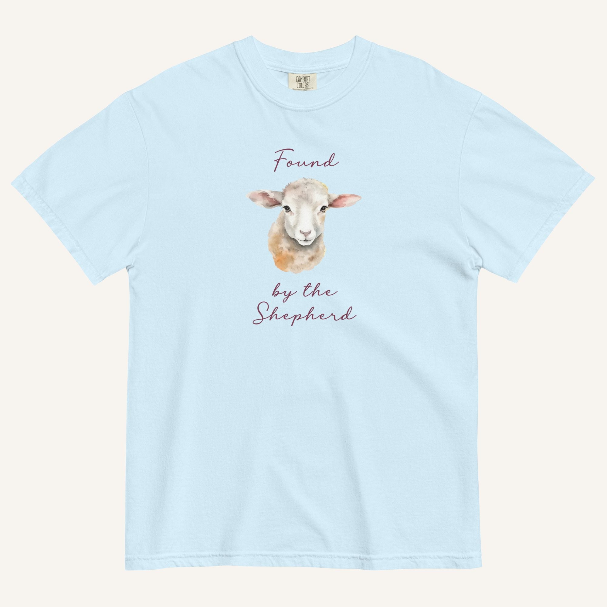 light blue t-shirt with watercolor lamb and 'Found by the Shepherd' text on cream background