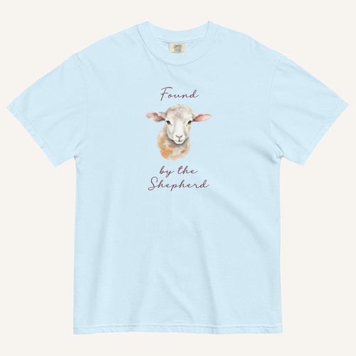 light blue t-shirt with watercolor lamb and 'Found by the Shepherd' text on cream background