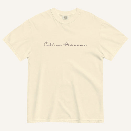Beige t-shirt with 'Call on His name' text on a white background