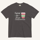 Dark grey Christmas T-shirt featuring the phrase “Fueled by Jesus …and peppermint mochas” with a festive peppermint mocha cup design.