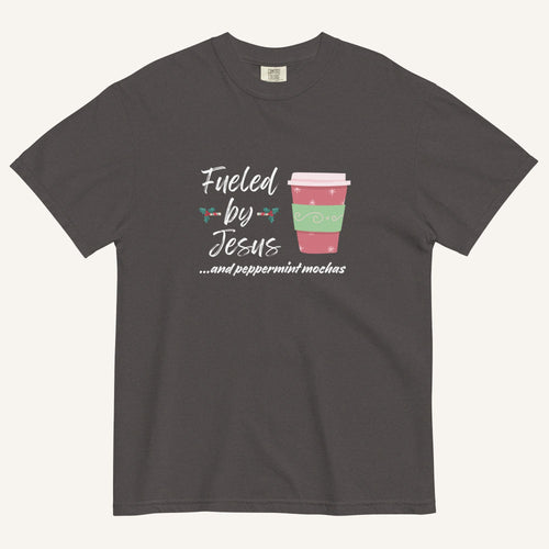 Dark grey Christmas T-shirt featuring the phrase “Fueled by Jesus …and peppermint mochas” with a festive peppermint mocha cup design.