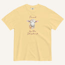 yellow t-shirt with watercolor lamb and 'Found by the Shepherd' text on cream background