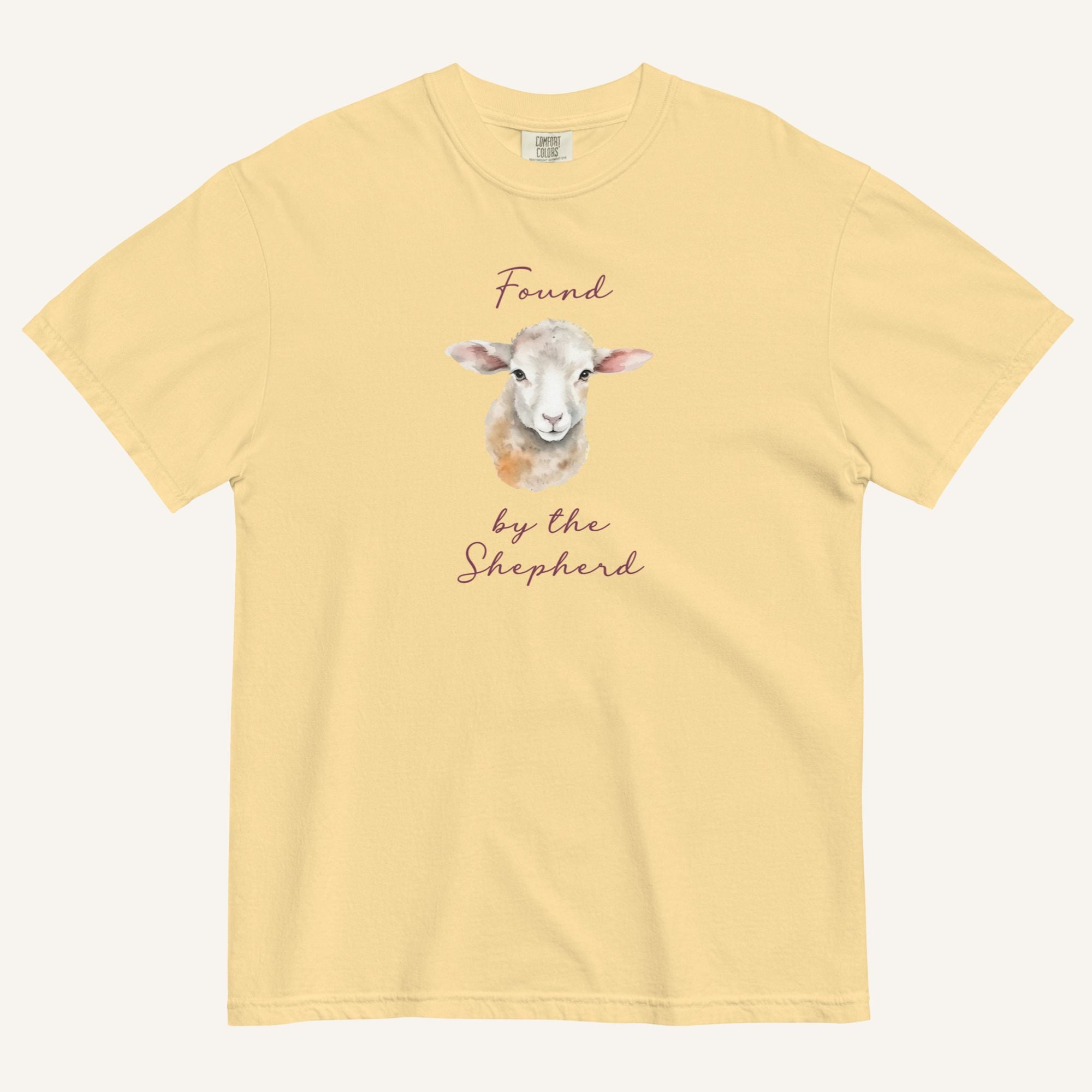 yellow t-shirt with watercolor lamb and 'Found by the Shepherd' text on cream background