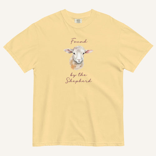 yellow t-shirt with watercolor lamb and 'Found by the Shepherd' text on cream background