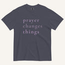 Navy blue t-shirt with 'prayer changes things' text on a white background
