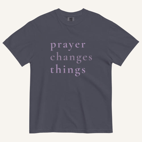Navy blue t-shirt with 'prayer changes things' text on a white background