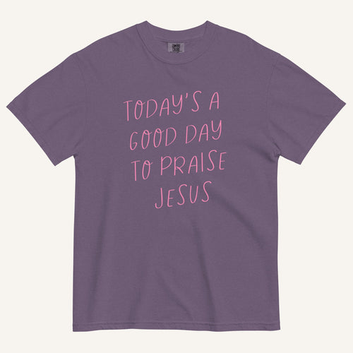 purple t-shirt with 'Today's a Good Day to Praise Jesus' pink text on a cream background