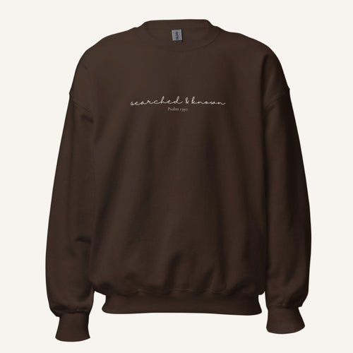 brown sweatshirt with 'Searched & known' text