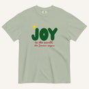 a muted sage green t-shirt with the words "Joy to the world, the Savior reigns" in bold colorful font with a star graphic