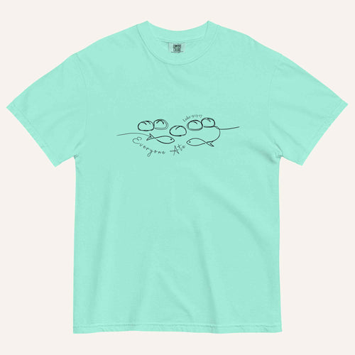 A mint blue/green short-sleeve crewneck t-shirt with a black graphic of two fish and 5 loaves of bread on a line and the cursive text 'Everyone Ate' across the chest, displayed flat against a light beige background.