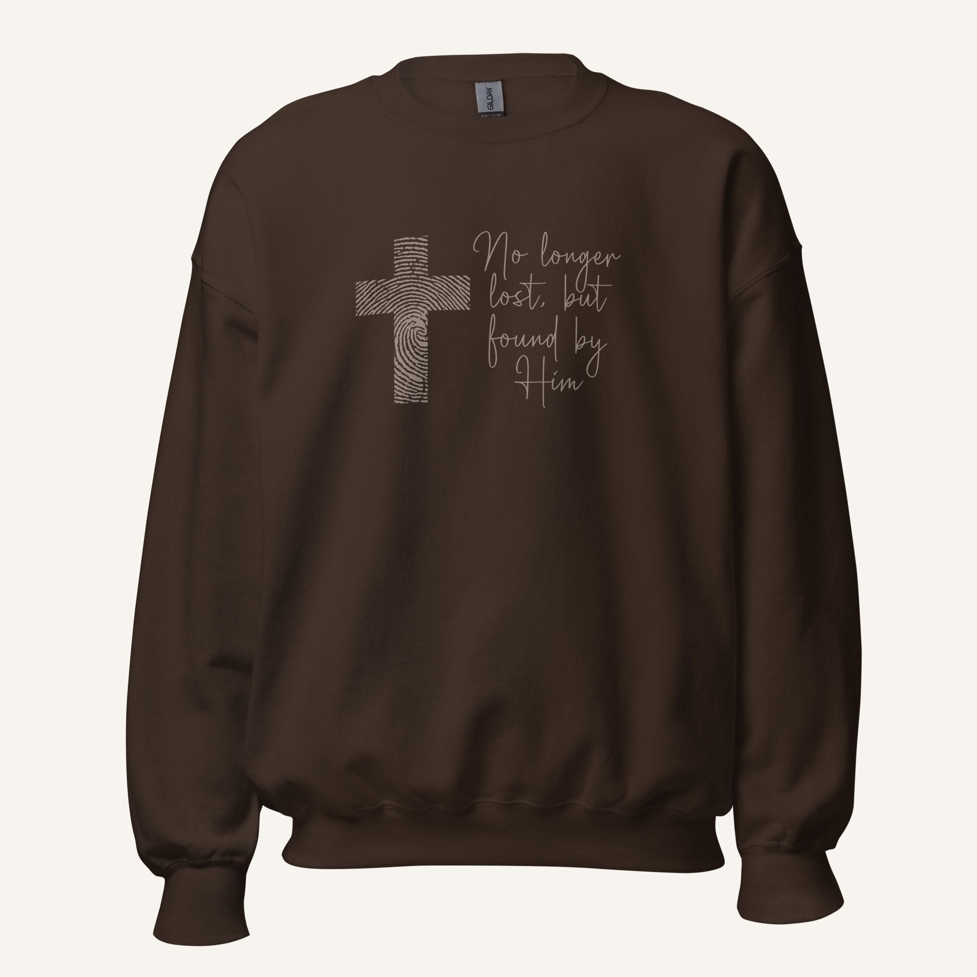brown sweatshirt with cross design and 'No longer lost, but found by Him' text on a cream background