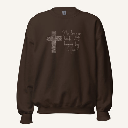 brown sweatshirt with cross design and 'No longer lost, but found by Him' text on a cream background