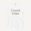 White t-shirt with 'Covered in Grace' text on a white background