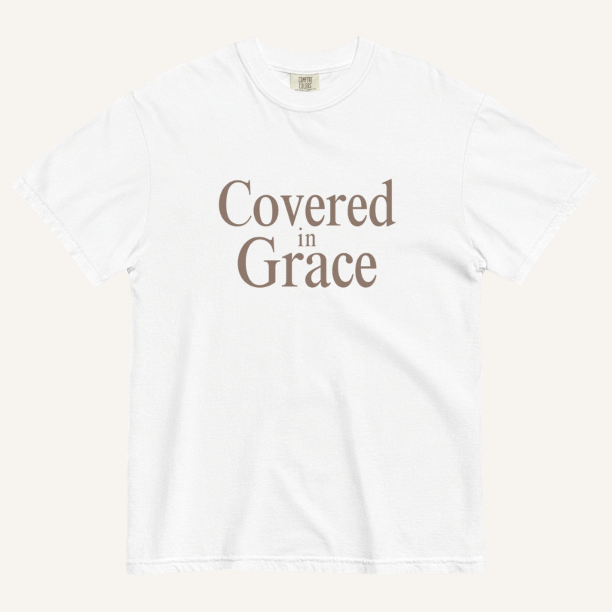White t-shirt with 'Covered in Grace' text on a white background