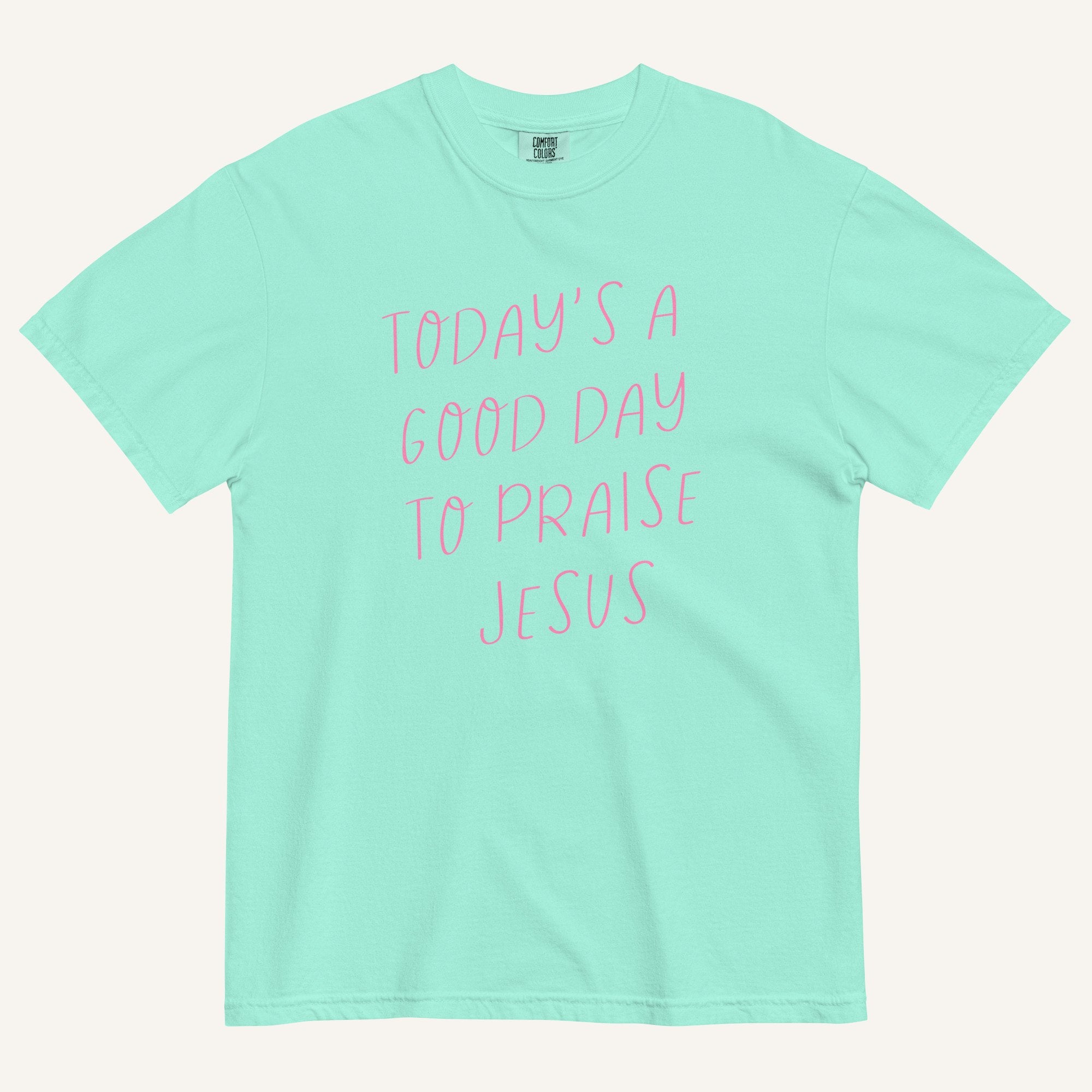 mint green t-shirt with 'Today's a Good Day to Praise Jesus' pink text on a cream background