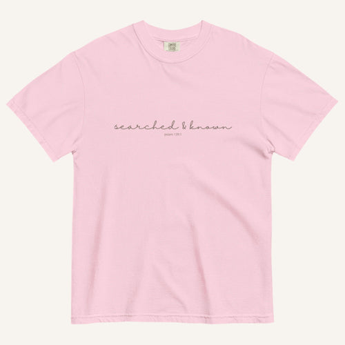pink t-shirt with 'Searched & Known' text on a cream background