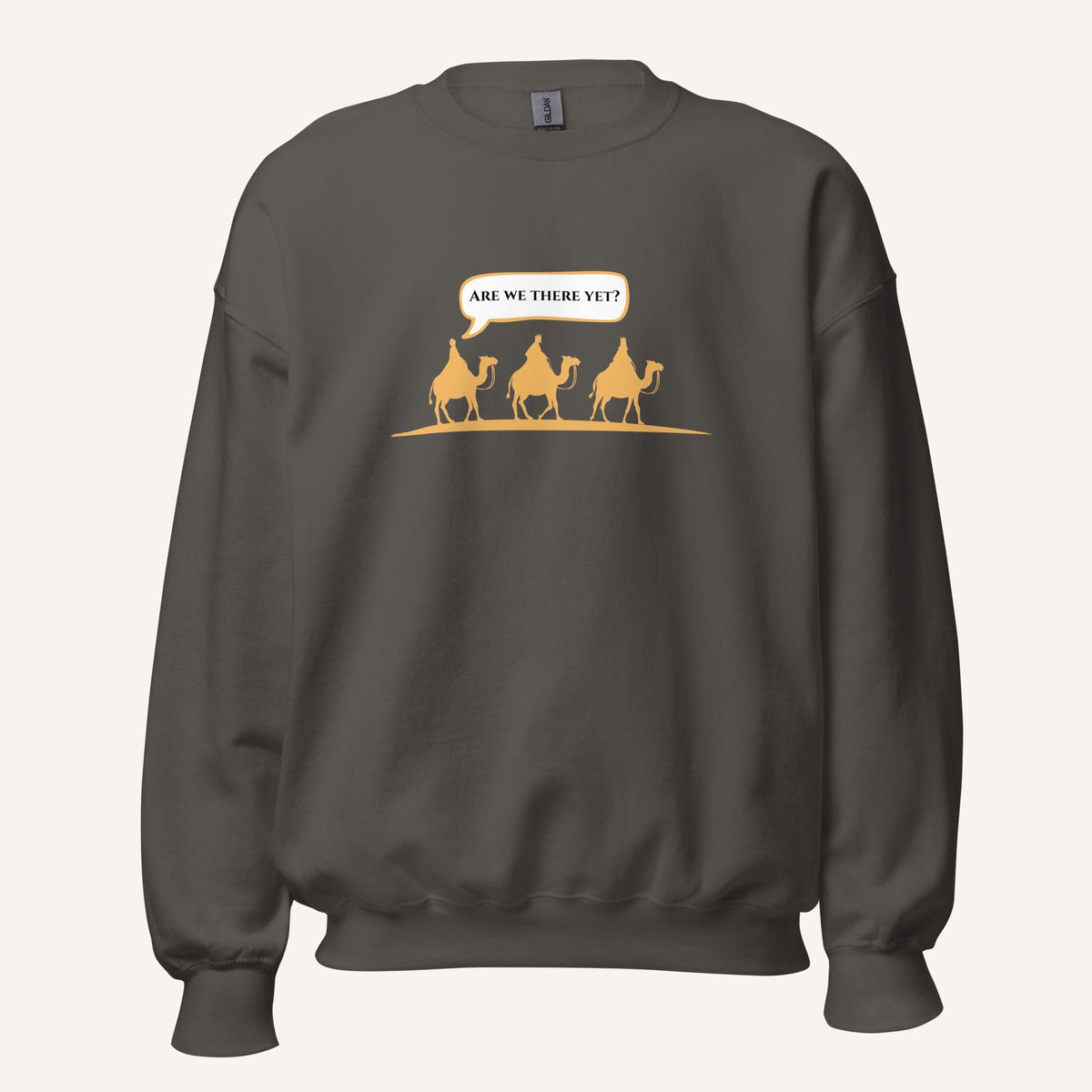 Grey unisex crewneck sweatshirt featuring a gold desert scene with three camels and a speech bubble reading “Are we there yet?”