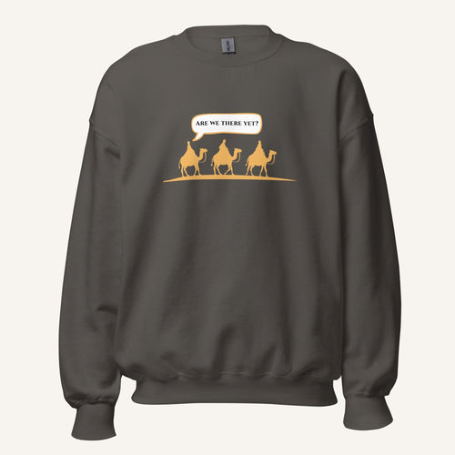 Grey unisex crewneck sweatshirt featuring a gold desert scene with three camels and a speech bubble reading “Are we there yet?”