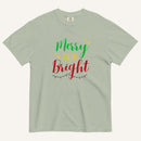 a muted sage green t-shirt that has "Merry & Bright" colored text with Christmas lights and star graphics