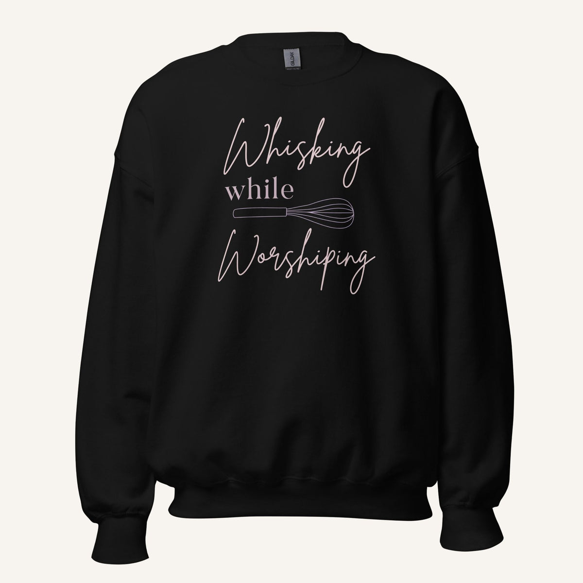 Black crewneck sweatshirt with "Whisking while Worshiping" pink text with a pink whisk graphic.
