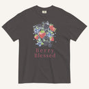 A dark charcoal gray t-shirt featuring a colorful watercolor graphic of strawberries, blueberries, and blackberries with the text 'Berry Blessed' printed below in pink, displayed against a light cream background.