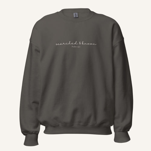 grey sweatshirt with 'Searched & known' text