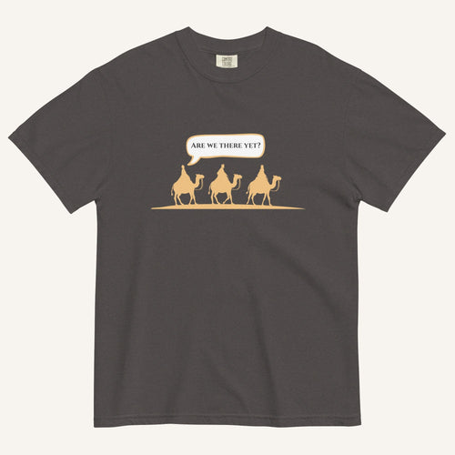 a dark grey t-shirt with 3 men riding camels in the color yellow with a chat bubble with the text "are we there yet?"