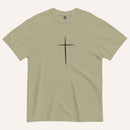 A short-sleeve crewneck t-shirt in a light olive green color, featuring a simple black Christian cross printed on the center chest. The t-shirt is laid flat against a solid, warm off-white background.