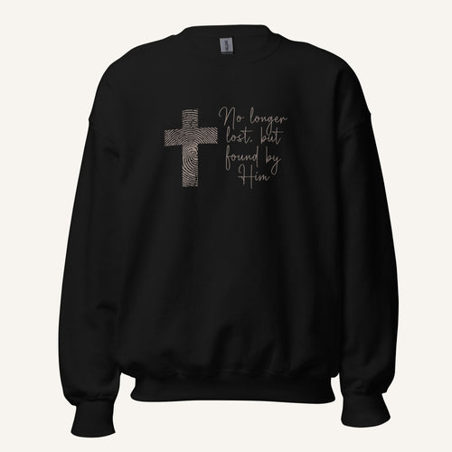 black sweatshirt with cross design and 'No longer lost, but found by Him' text on a cream background