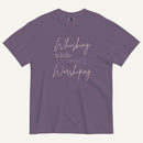 purple t-shirt with "Whisking while worshiping" text and a whisk graphic