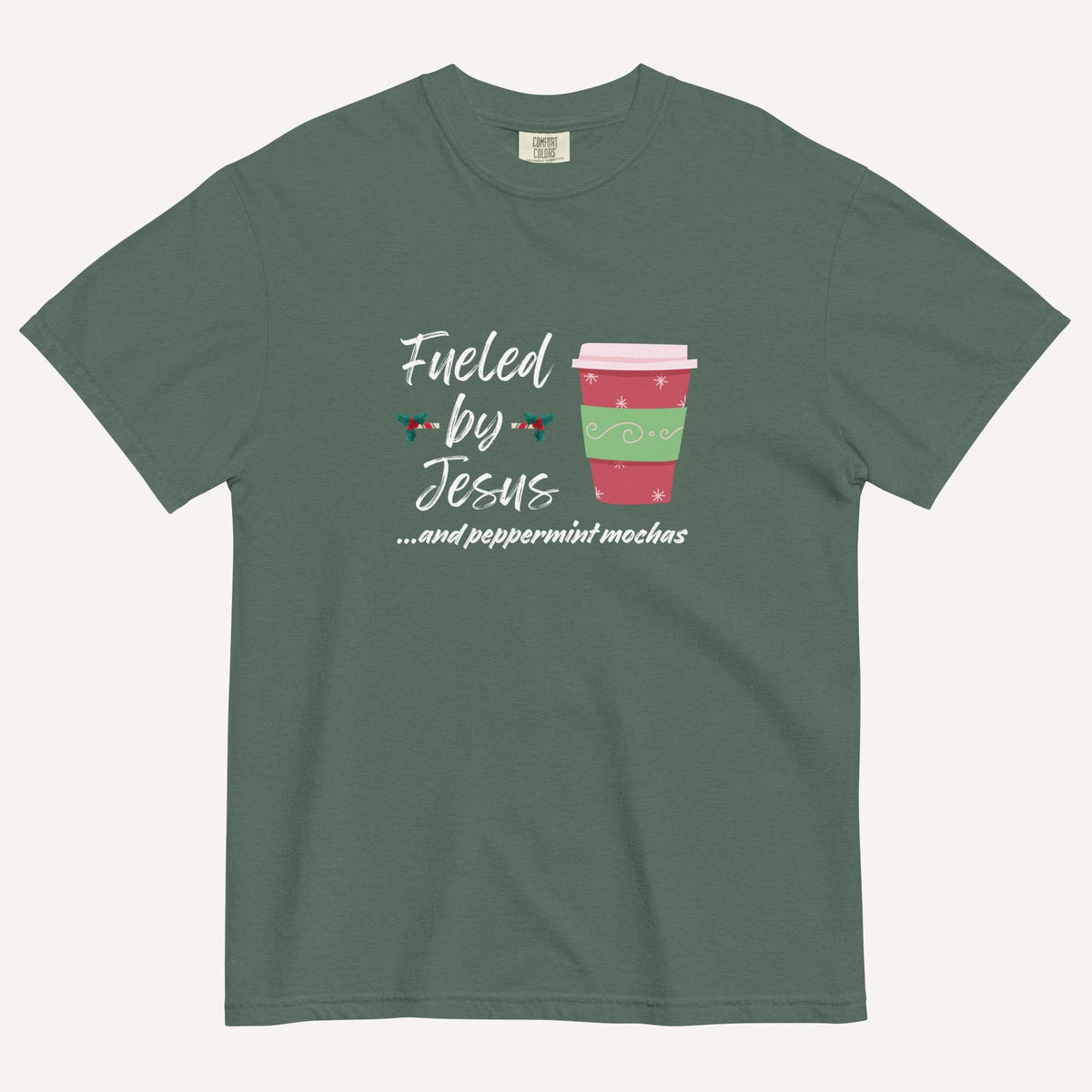 Blue spruce Christmas T-shirt featuring the phrase “Fueled by Jesus …and peppermint mochas” with a festive peppermint mocha cup design.