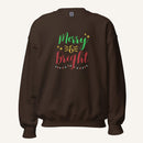 brown crewneck sweatshirt with "Merry & Bright" colorful text with Christmas lights and star graphics