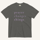 Gray t-shirt with 'prayer changes things' text on a white background