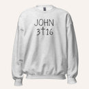 a light heather grey crewneck sweatshirt with 'John 3 16' text with cross graphic between the 3 & 16 on a light cream background