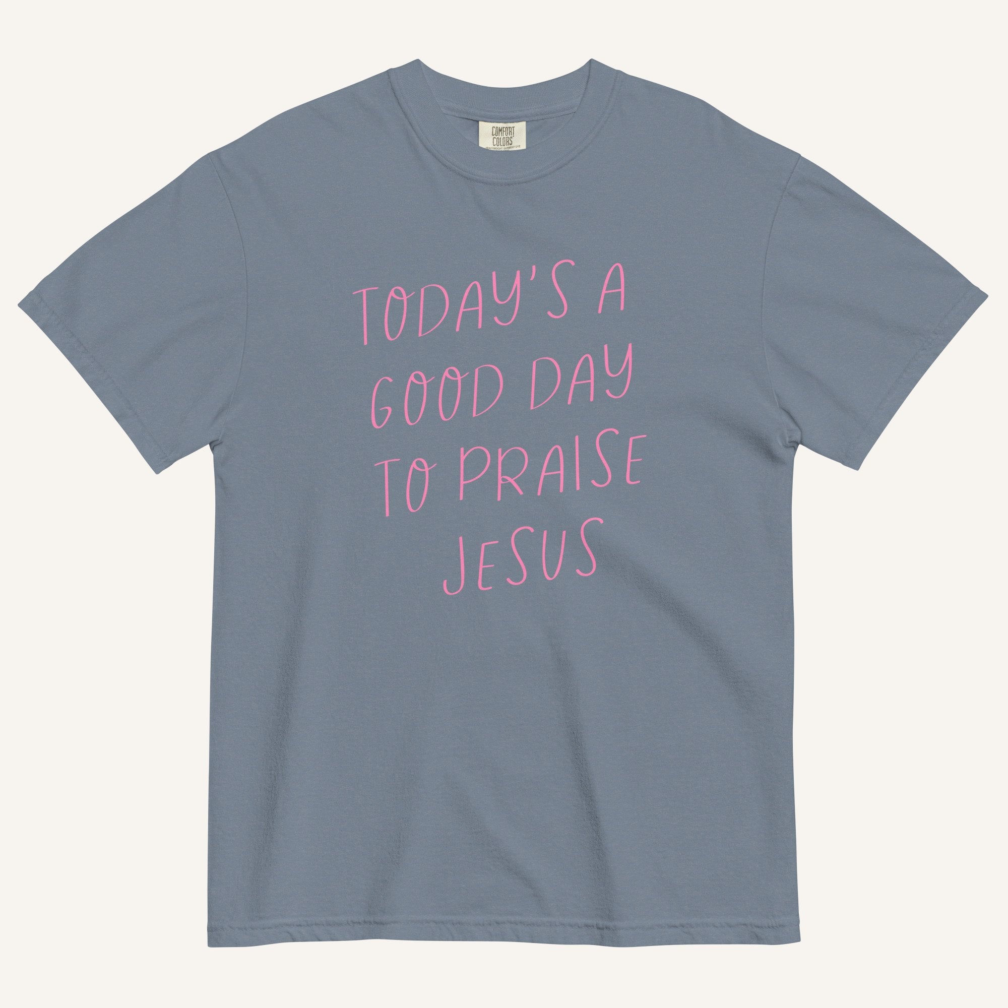 light muted blue t-shirt with 'Today's a Good Day to Praise Jesus' pink text on a cream background
