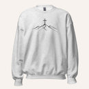 A light ash grey crewneck sweatshirt featuring a black line art graphic of a cross on top of simple mountains on the chest, displayed against a solid off-white background.